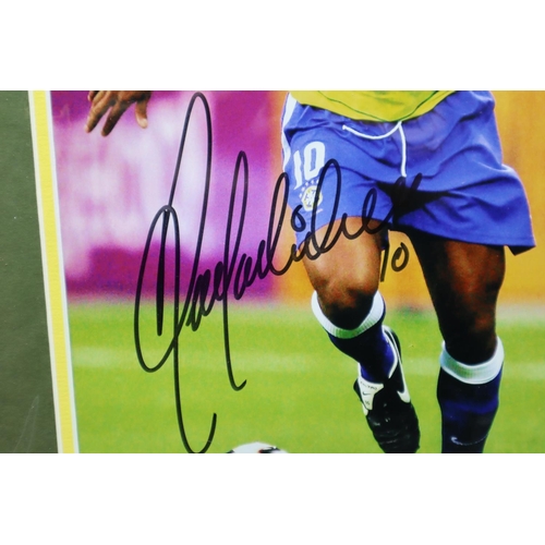 96 - Ronaldinho signed 16x12 mounted colour photo pictured in action for Brazil.