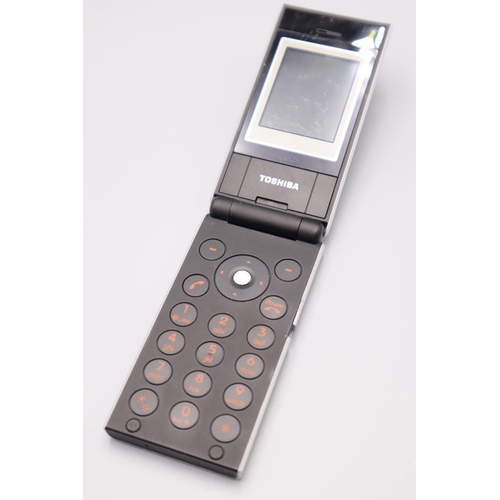 307 - Toshiba TS10 Flip Phone complete with Charger, Headphones and Booklet Working When tested