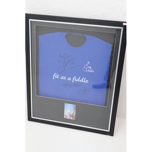 78 - Nobby Stiles Signed Fit as a Fiddle Charity Shirt with two unidentified Signatures in Framed and Gla... 