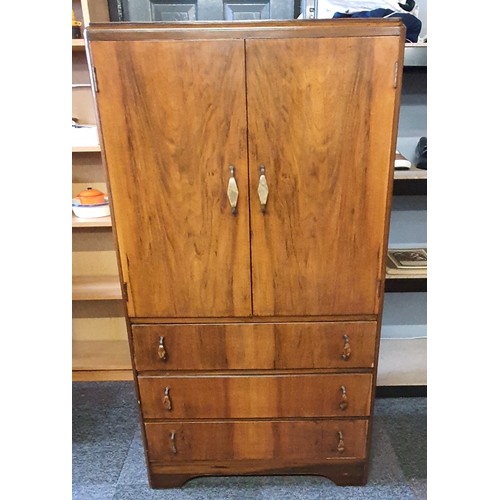 25 - A Two Door, 3 Drawer Tallboy . It is 54 inches tall, x 30 wide and 17 deep approx .