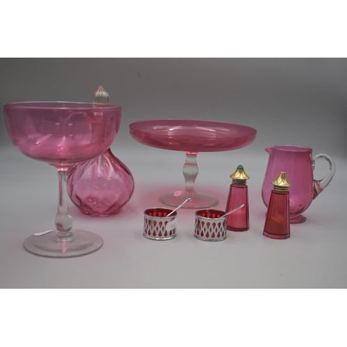 182 - Eight Pieces of Cranberry Glass Includes Fruit Bowl on Clear Pedestal, Cruets, Vinegar Jug, Large Gl... 