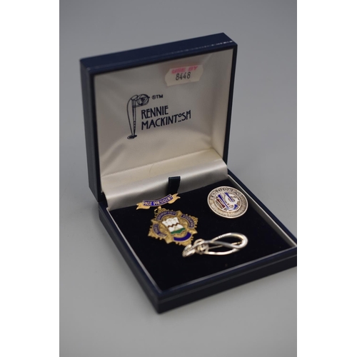 50 - Three Silver Badges / Brooches including Mackintosh Style and Mappin & Webb