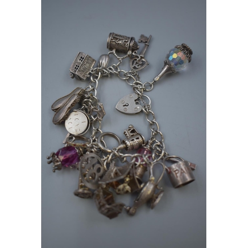 10 - Hallmarked Silver Charm Bracelet with approx Seventeen Charms