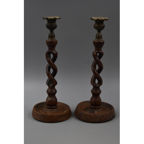 205 - A Pair of Antique Wooden Brass Topped Candle Sticks 12 Inches Tall