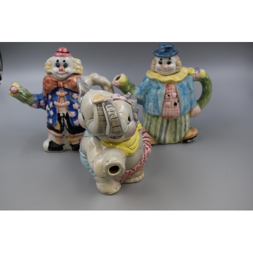 542 - Mixed lot of seven decorative tea pots, knights, castles, clowns and elephant, also one Hornsea squi... 