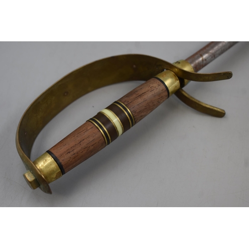 275 - A Fire Poker, In The Design of A Sword With a Brass and Wooden Handle. Approx 22.5