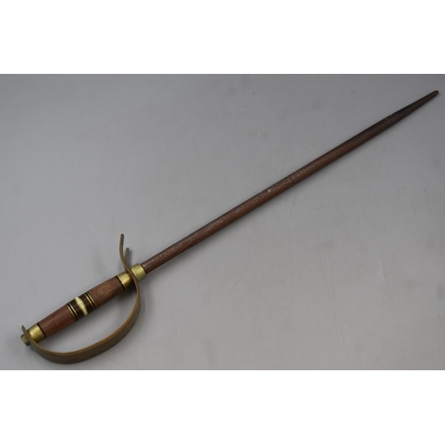 275 - A Fire Poker, In The Design of A Sword With a Brass and Wooden Handle. Approx 22.5