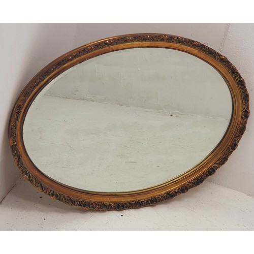 68 - Large Heavy Ornate  Gilt Framed, Bevelled Edge Oval Mirror. Measures Approx 33 x 23 Inches