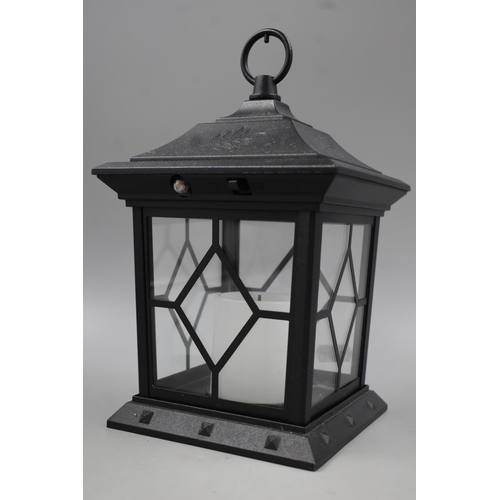 585 - Two Decorative Metal and Glass Garden Lanterns complete with Candles