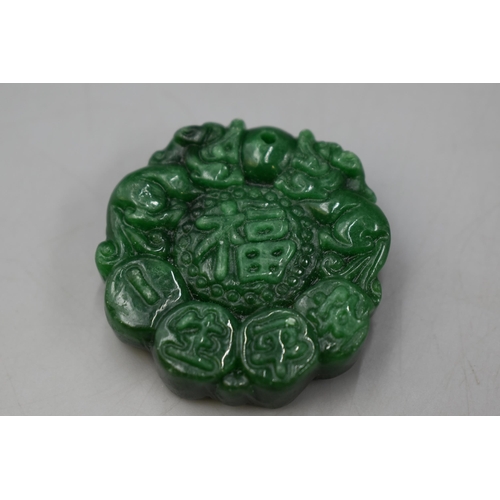 68 - A Green Stone Chinese Pendant, 'Happiness and Peace'.