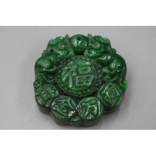 68 - A Green Stone Chinese Pendant, 'Happiness and Peace'.