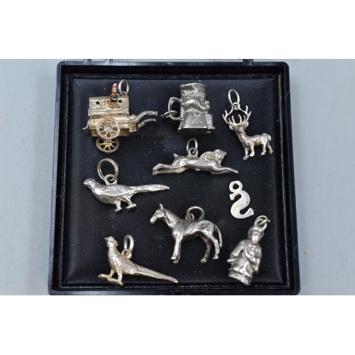 63 - Collection of Nine Silver Charms