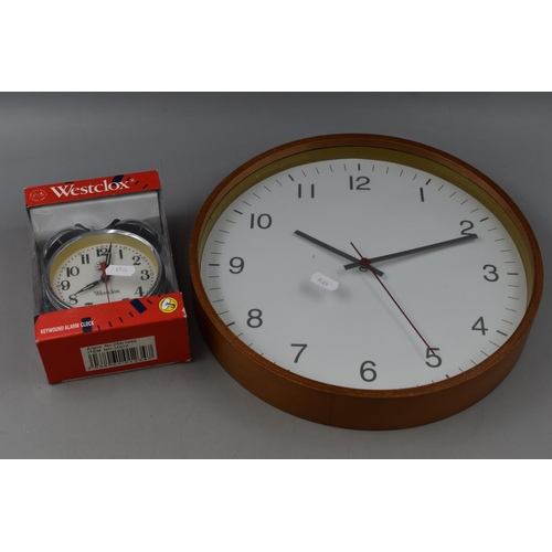 675 - Boxed Westclox Clockwork Alarm Clock and A Wood Framed Quarts Wall Clock Approx 12 Inch Diameter