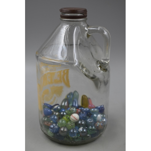 142 - A Selection of Glass Marbles, In A Greenall's Beer Jug.