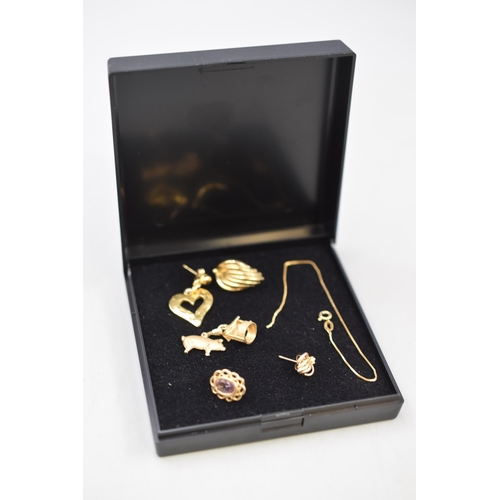 2 - A Selection of Scrap 9ct Gold Pieces. Includes Charm, Earrings and Other. (6.04 grams)