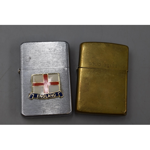 84 - Two Lighters. Includes Zippo Solid Brass (Needs New Flint) and Surrey England.