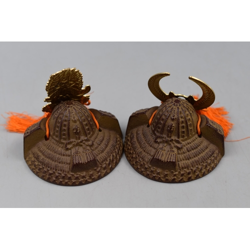 187 - Two Cast Metal Miniature Samurai Helmets