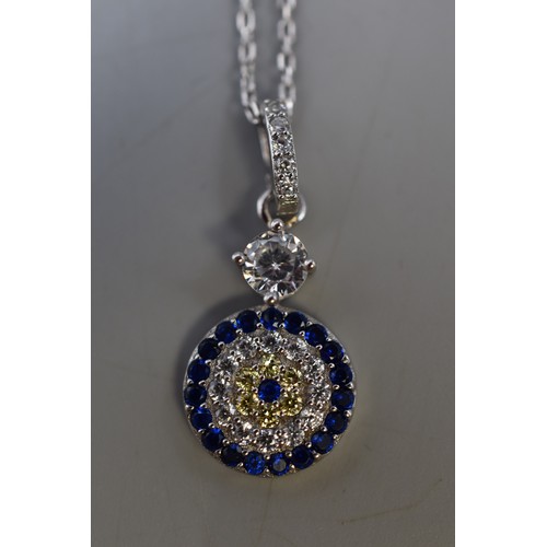 76 - A Concentric 925. Silver Pendant With Clear, Blue and Yellow Stones, On 925 Silver Chain. With Prese... 