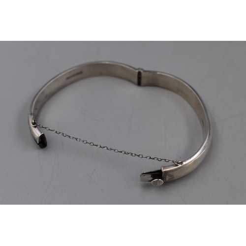 43 - A Hallmarked Birmingham Etched Silver Bangle With Safety Chain.