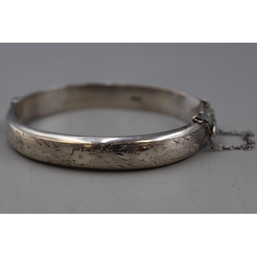 43 - A Hallmarked Birmingham Etched Silver Bangle With Safety Chain.