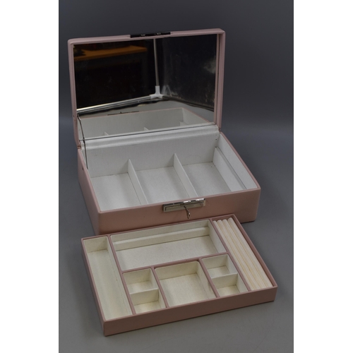 438 - A Pink Leather Effect Jewellery Box, With Mirror and Key. Approx 8.5