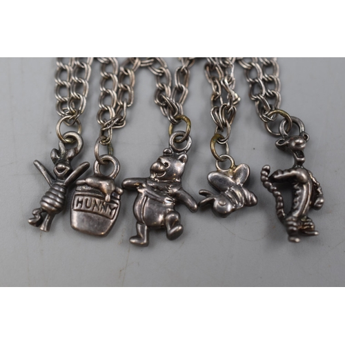 120 - A 925 Silver Charm Bracelet With Five Winnie The Pooh Themed Silver Charms.