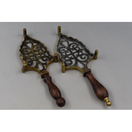 341 - Pair of Brass Trivets with Wooden handle in the shape of an Iron