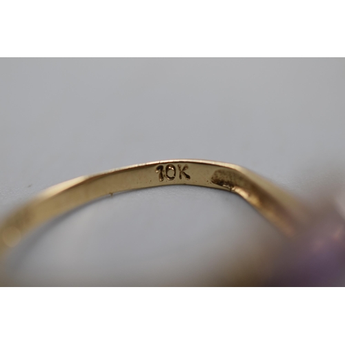 10 - A 10k Gold Purple Stoned Multi Size Ring.