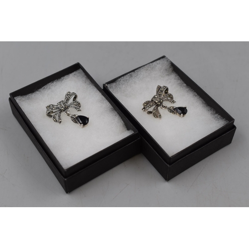 18 - Two Silver Marcasite Black Stoned Brooches in Display Cases