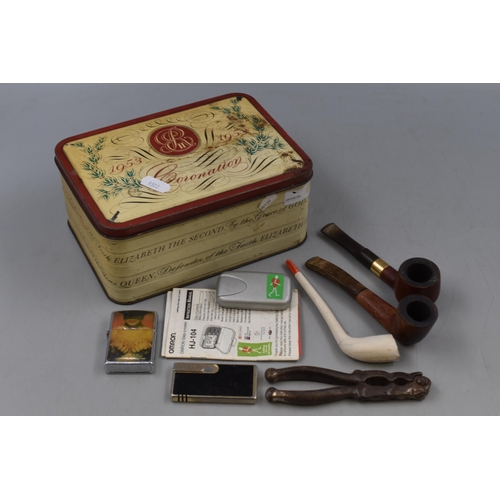 408 - A Vintage Tin With Contents. Includes Smoking Pipes Lighters and More.