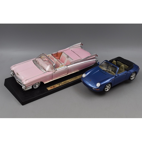 550 - Two Die Cast Vehicles; A Maisto Pink Cadillac Eldorado Bairritz (1:12), And Bburago Porsche Carrera ... 