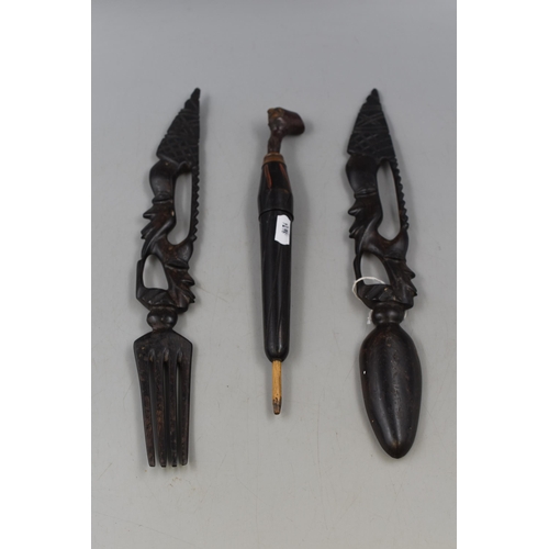 276 - A Selection Wooden Handcarved Ethnic Pieces. Includes Cutlery, Wooden Umbrella Container and More.