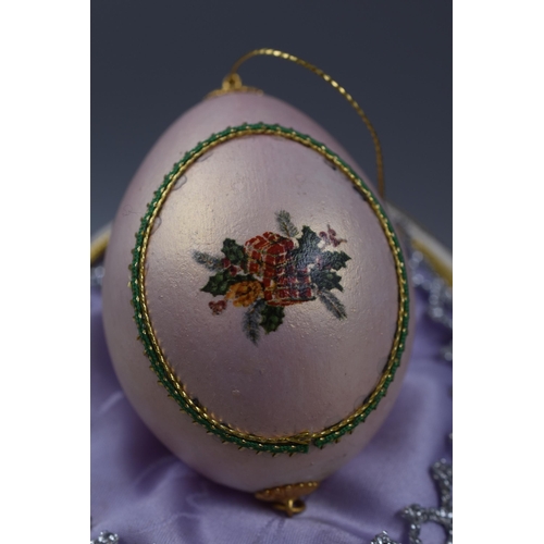 106 - Two Hand Painted Ostrich Eggs one in the style of Faberge wit smaller egg inside