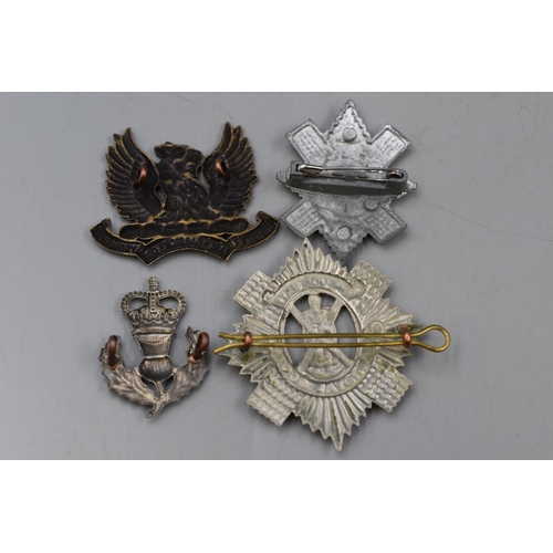 127 - Four Military Cap Badges. Includes The Royal Scots, Scottish Thistle, Ayrshire and Other.