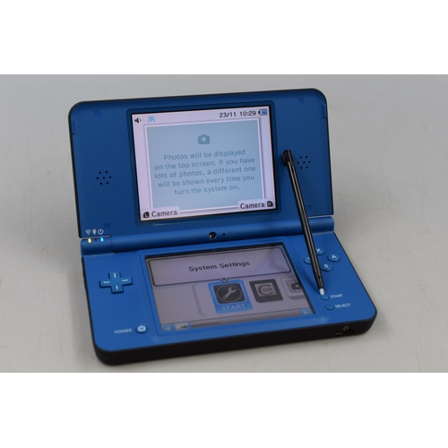 322 - Nintendo DSi XL and Five Games with instructions and power lead powers on when tested