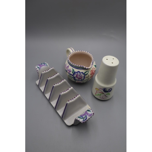 34 - Selection of Poole Pottery to include Milk Jug, Toast Rack and Pepper Shaker.