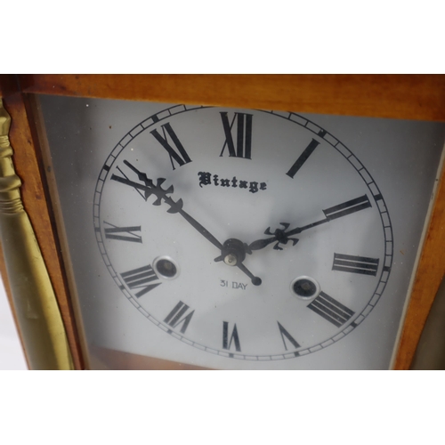 373 - A Vintage 31 Day Wall Clock With Key and Brass Embellishments. Approx 24