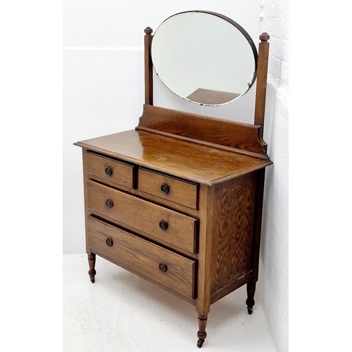 569 - Vintage Chest of 4 Drawers 2 over 2 with Oval Mirrored Top which is removable. Stands on wheeled leg... 