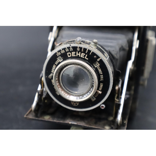 353 - A Dehel folding camera and case.