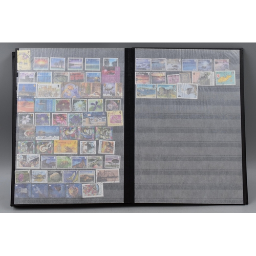 450 - Stanley Gibbons Album Containing a Large Selection of Stamps From New Zealand, Isle of Man and Guern... 