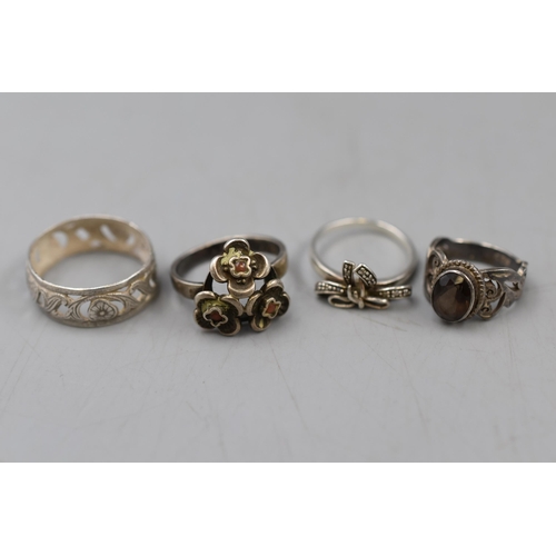 8 - A Selection of Four Rings Including Three Silver.