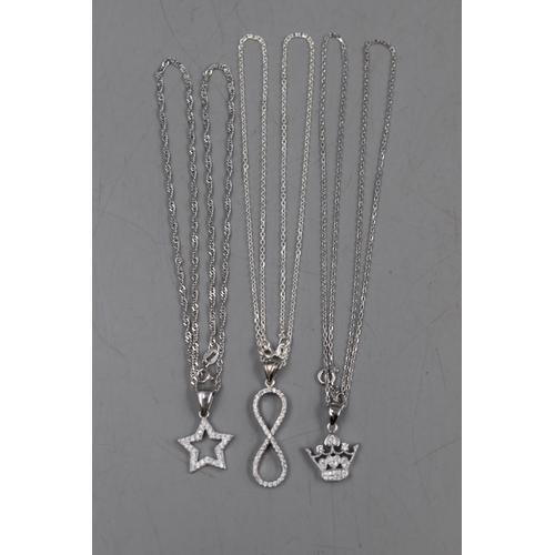 12 - A Selection of Three 925. Silver Pendants on 925. Silver Chains. Includes Star, Crown and Infinity.