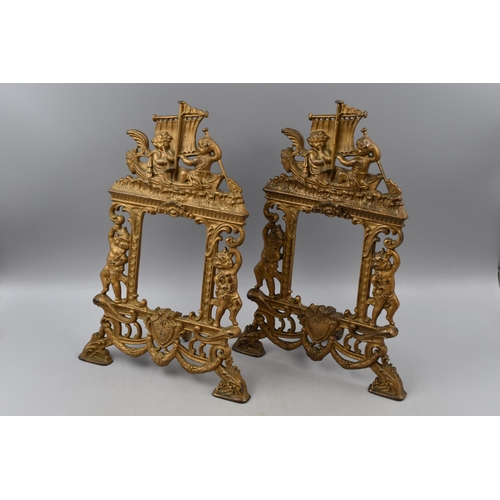 167 - A Pair of Vintage Ornate Cast Iron Picture Frames Depicting Cherubs, With Registered Number. Approx ... 