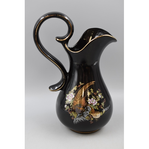 230 - A Black Gilt Ceramic Jug and Bowl, Depicting Birds. AF