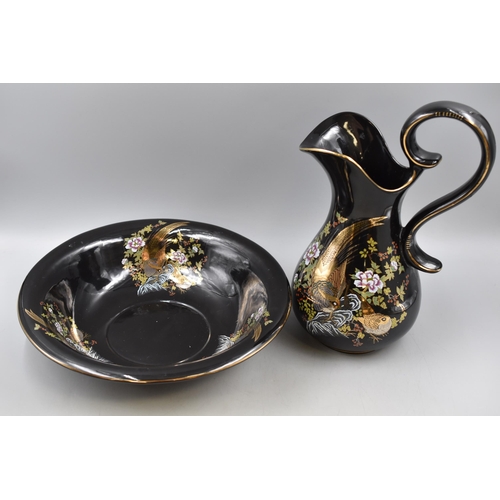 230 - A Black Gilt Ceramic Jug and Bowl, Depicting Birds. AF