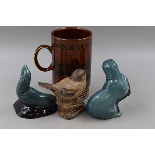 131 - A Selection of Four Pieces of Poole Pottery, Includes Seal, Otter, Commemorative Mug and Sparrow (AF... 