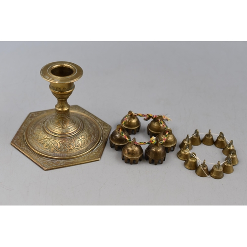 181 - An Indian Brass Candleholder, A Set of Six Small Claw Temple Bells, and Ten Small Brass Bells.