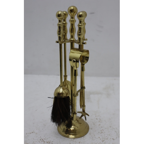 192 - A Four Piece Brass Companion Set, With A Brass Fire Front.