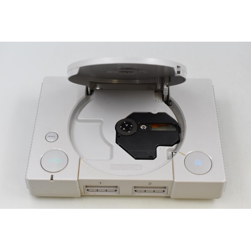 430 - A Sony Playstation, With Two Controllers and 1mb Memory Card. Powers on When Tested.