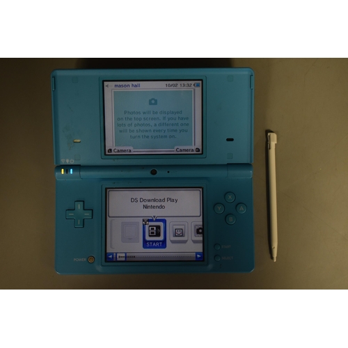 245 - A Nintendo DSi In Light Blue, With a Selection of 32 DS Games In Four Games Cases. Includes Pokemon ... 